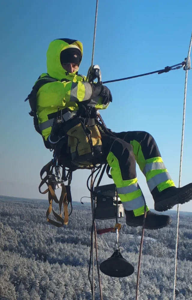 Rope access technician hanging in the sky